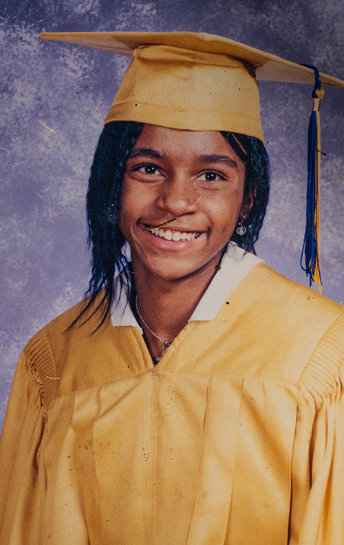 Graduation photograph of Shantieya Smith as she poses in a yellow graduation gown